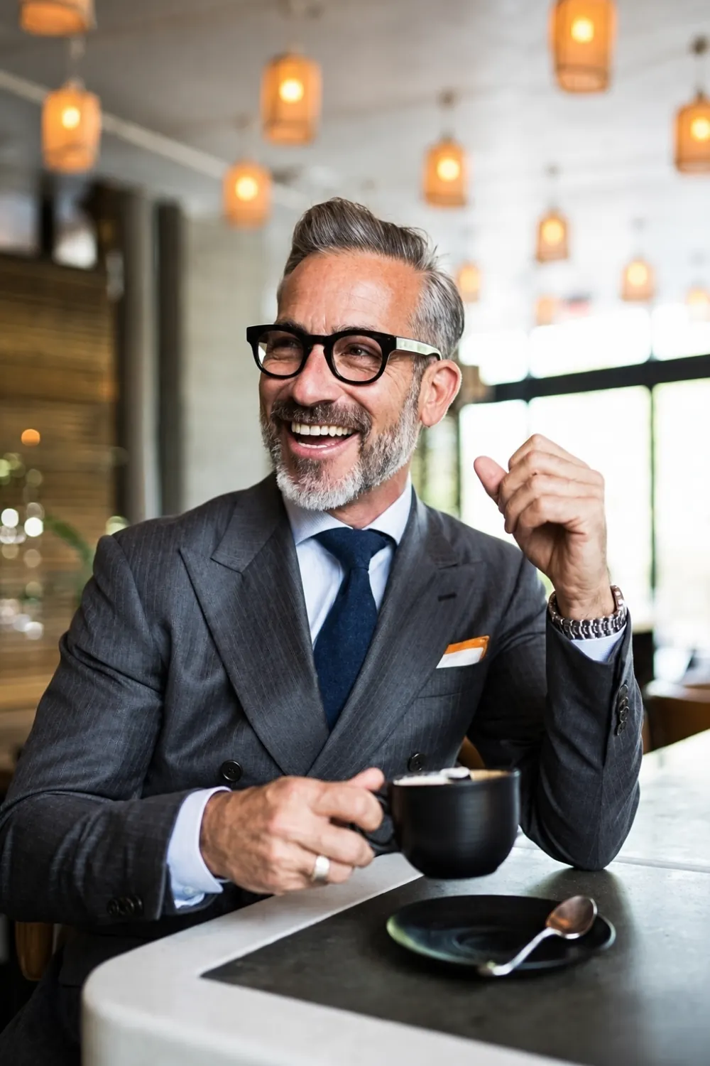 Older man smiling over coffee in a café